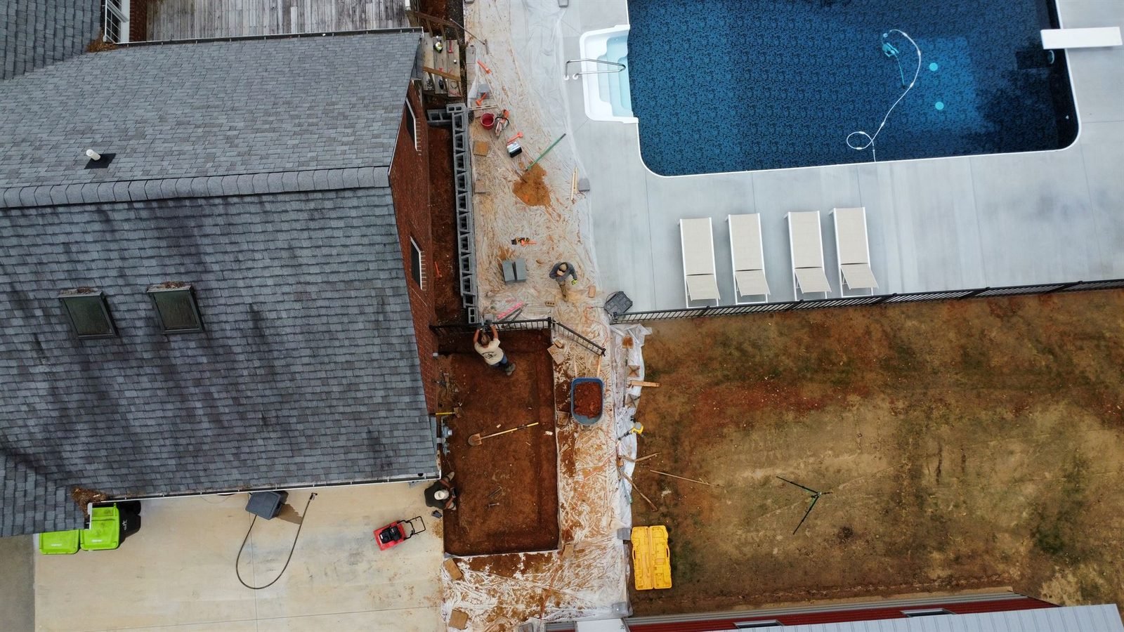 Aerial view of pool patio and retaining wall under construction Western NC