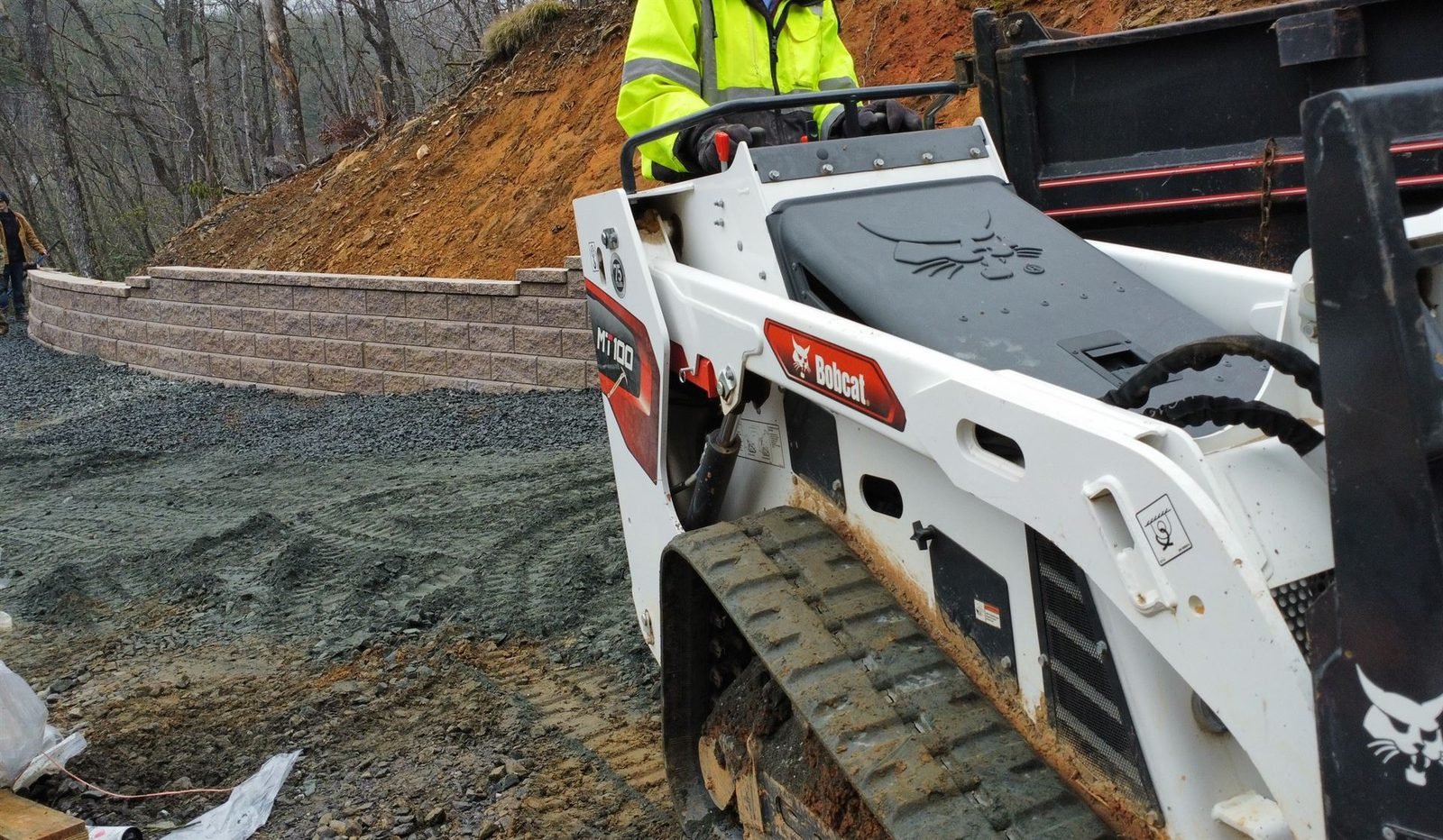 Mini skid steer building curved retaining wall Western NC