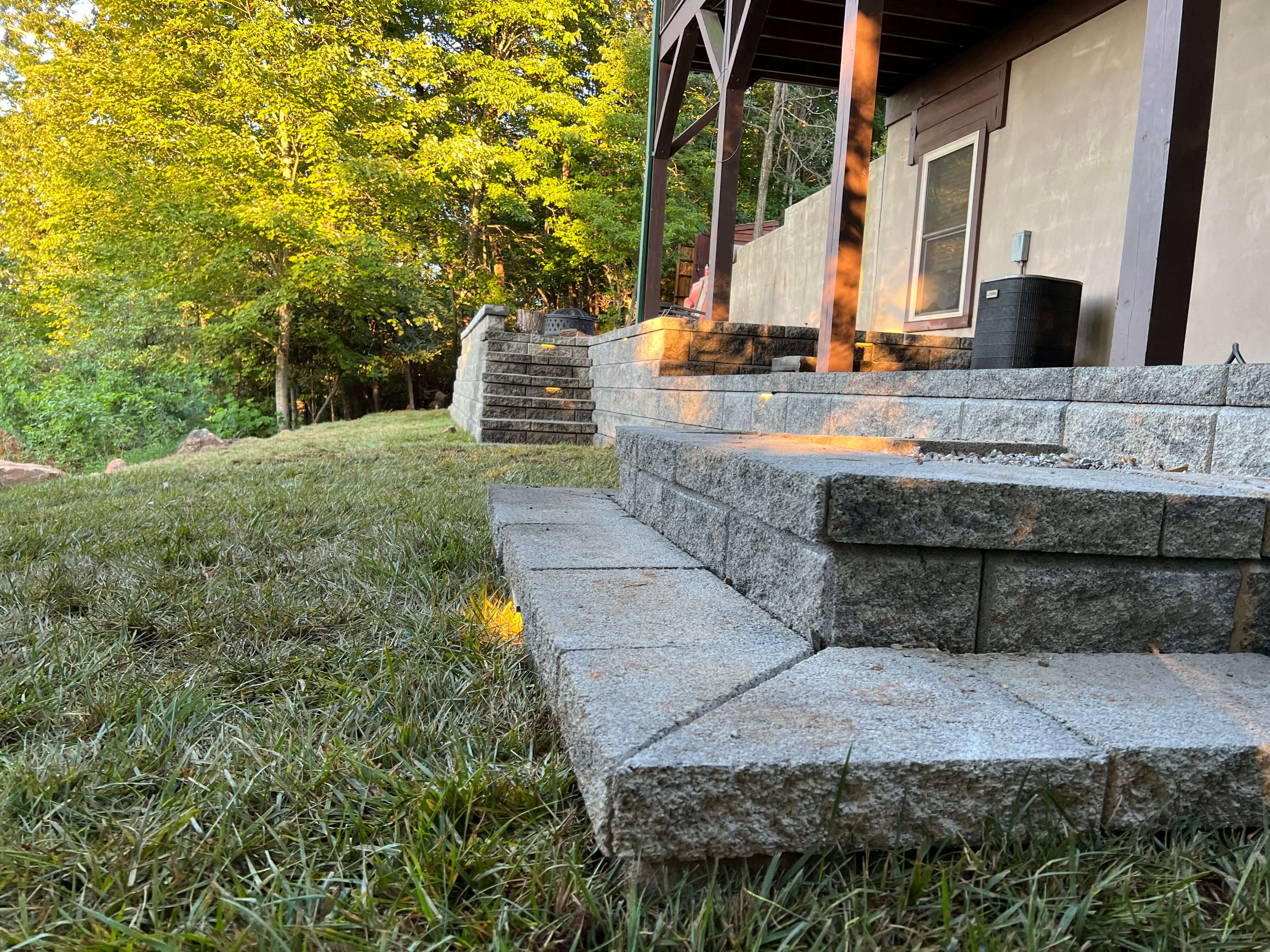 Completed outdoor living space with patio and plant installation in Western NC